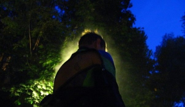 river surfer removing a drysuit at night